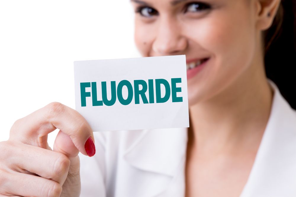 woman holding fluoride label